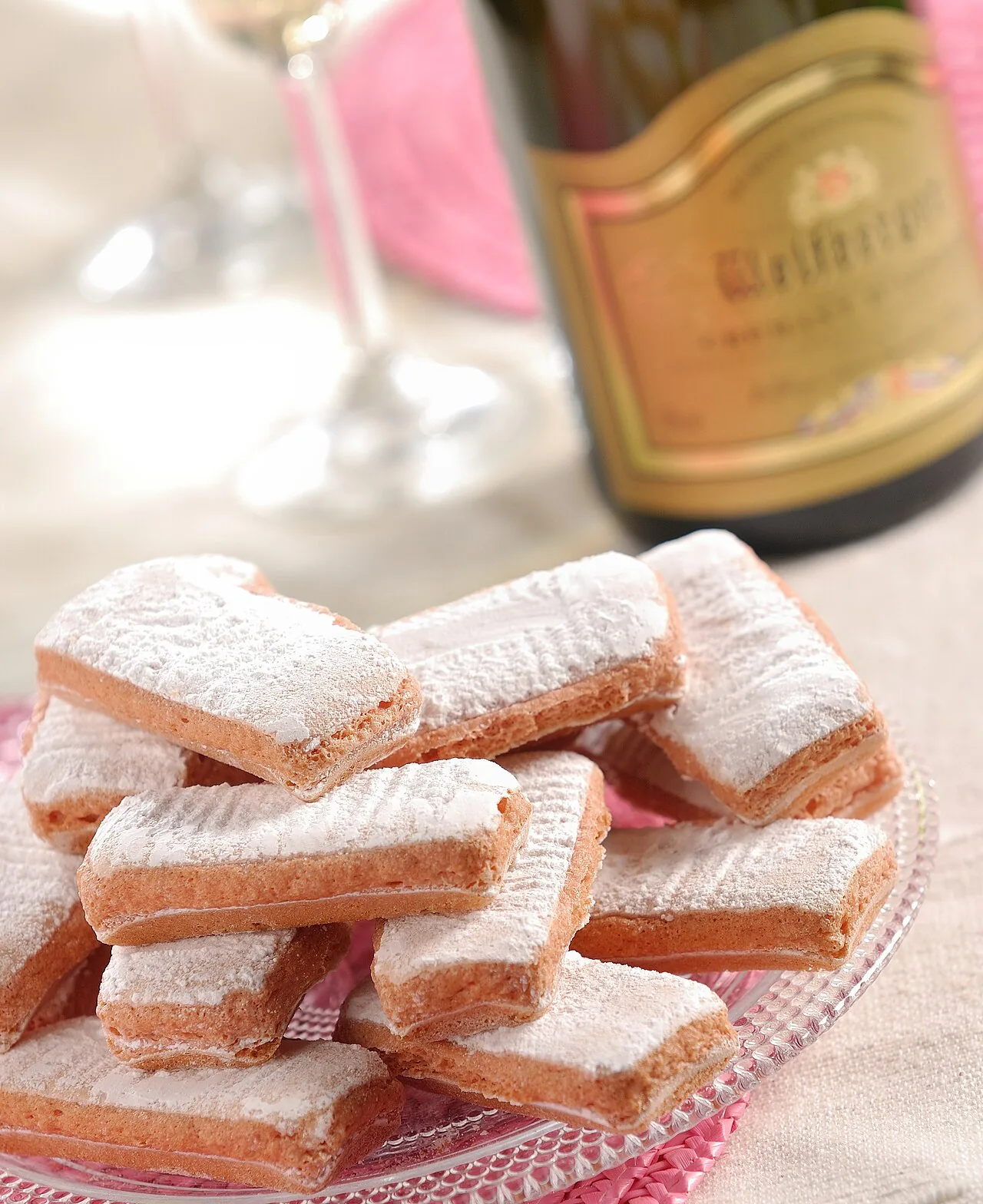Pink biscuits of Reims served beside a Champagne bottle